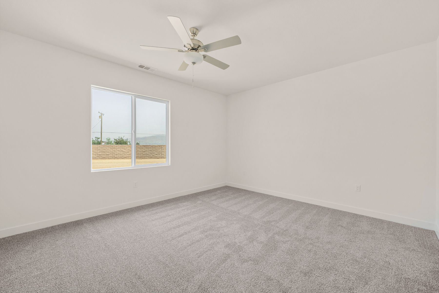 The master bedroom is spacious and has carpet