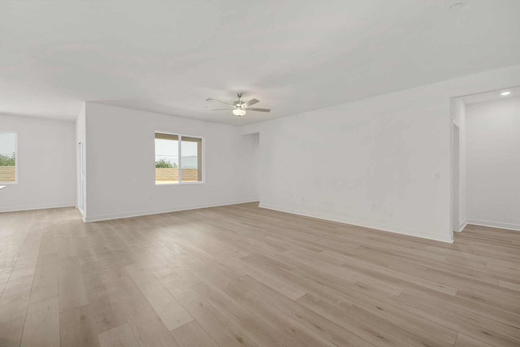 The family room is spacious with a ceiling fan.