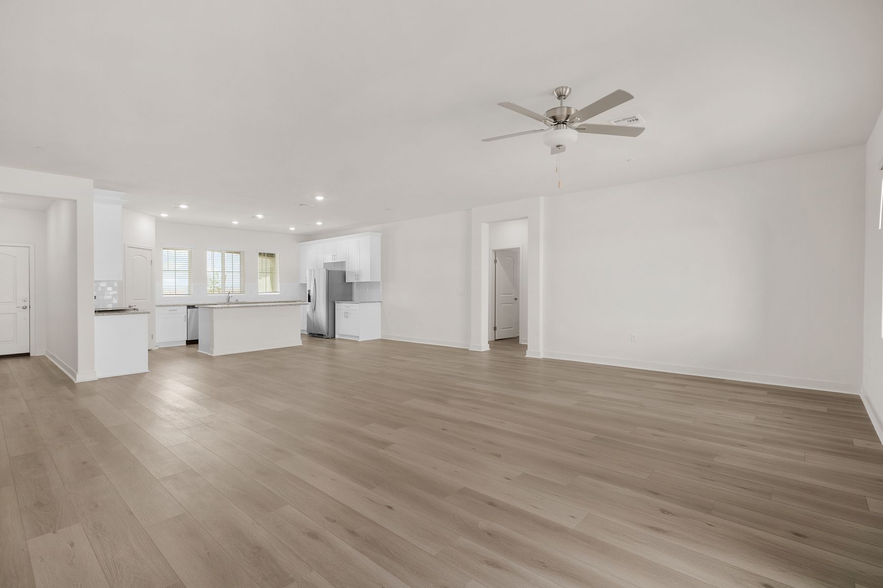 The family room is spacious with a ceiling fan.