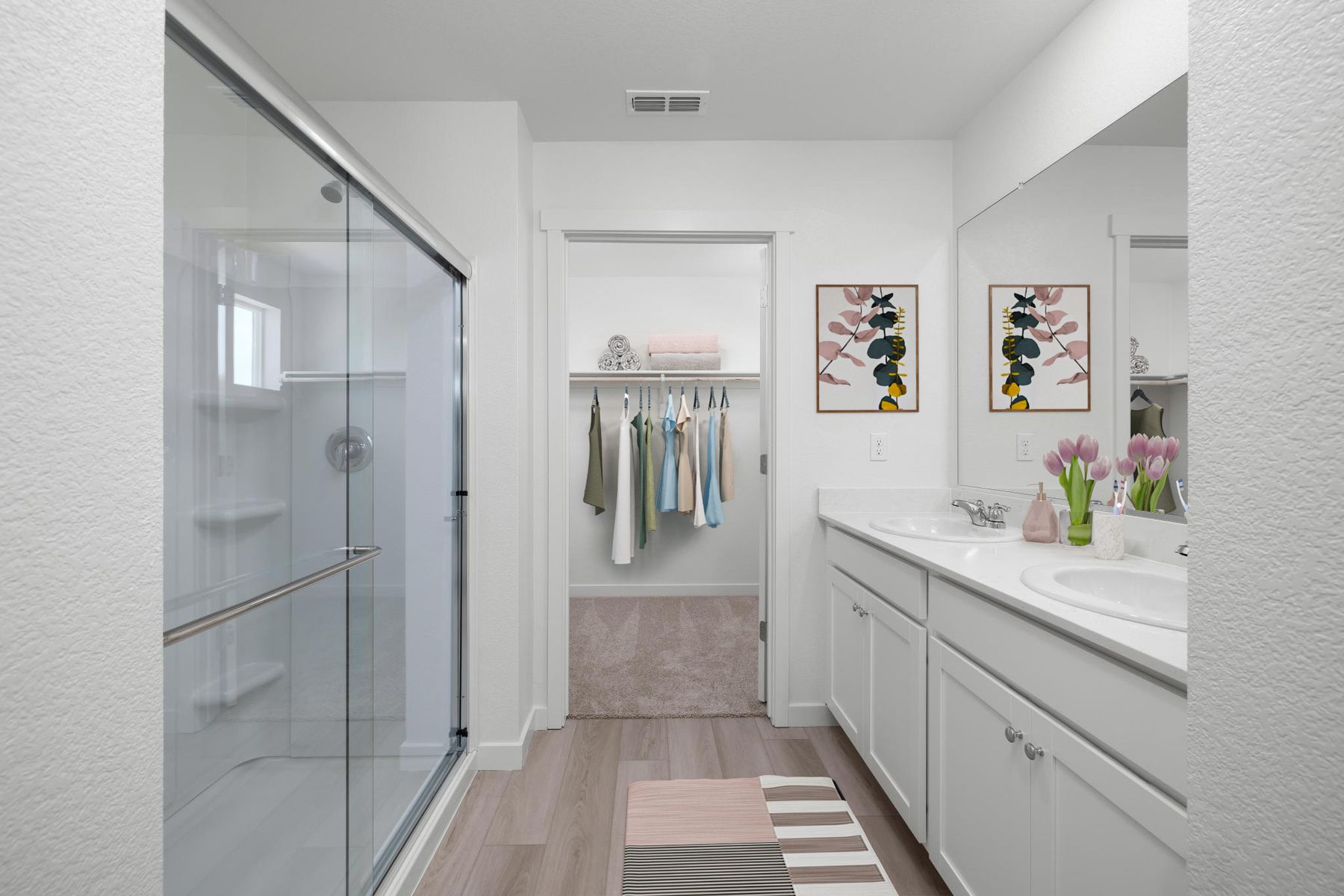 The master bathroom has a large vanity and a step in shower.