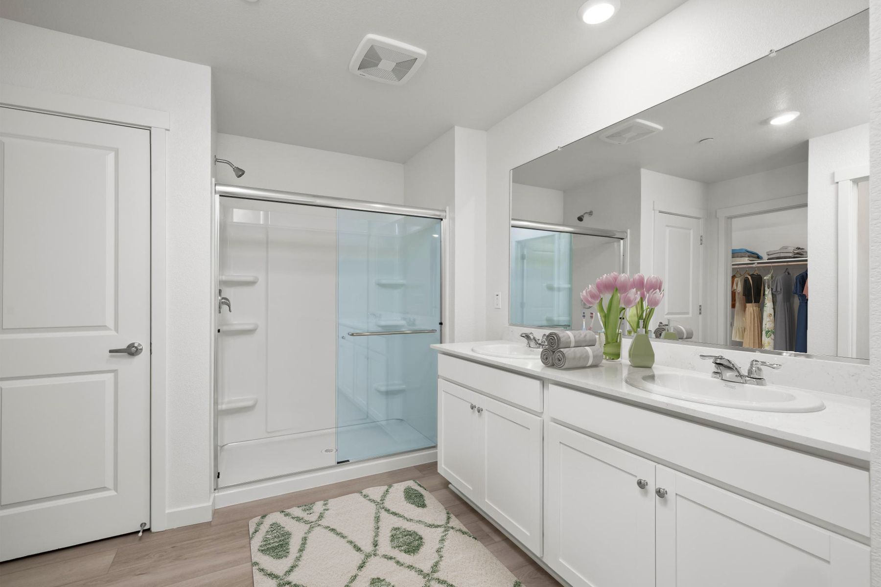 The master bathroom has a large vanity and a step in shower.