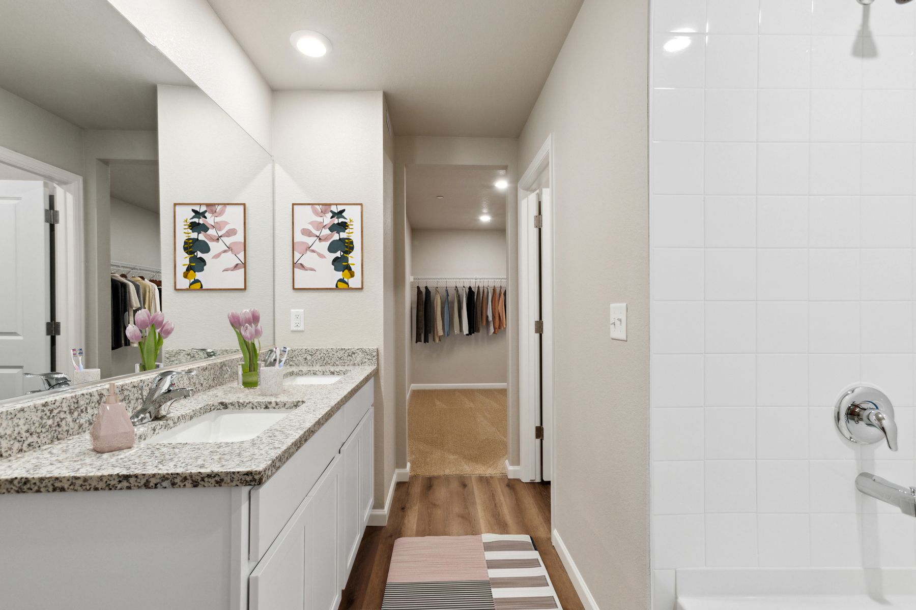 The master bathroom has a large vanity and a step in shower.