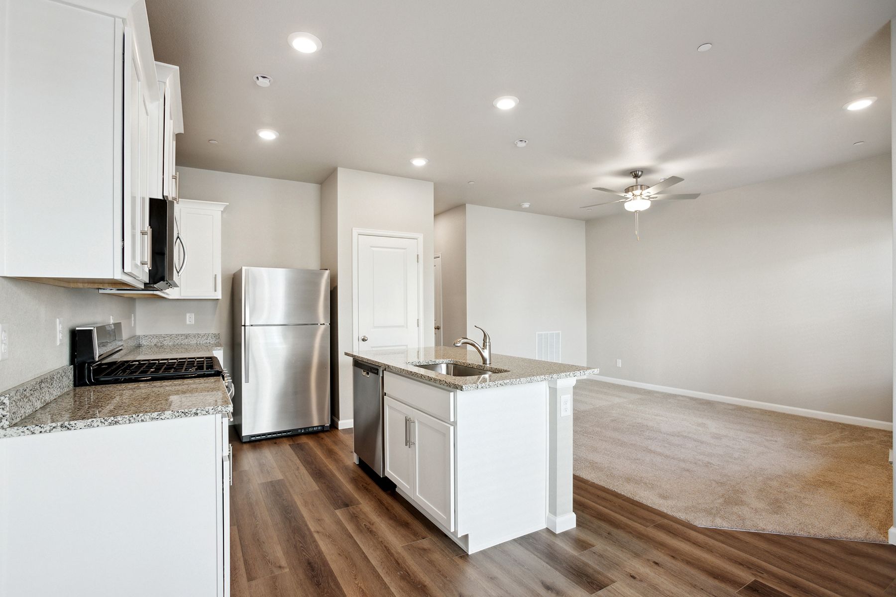 The family room is spacious with a ceiling fan.