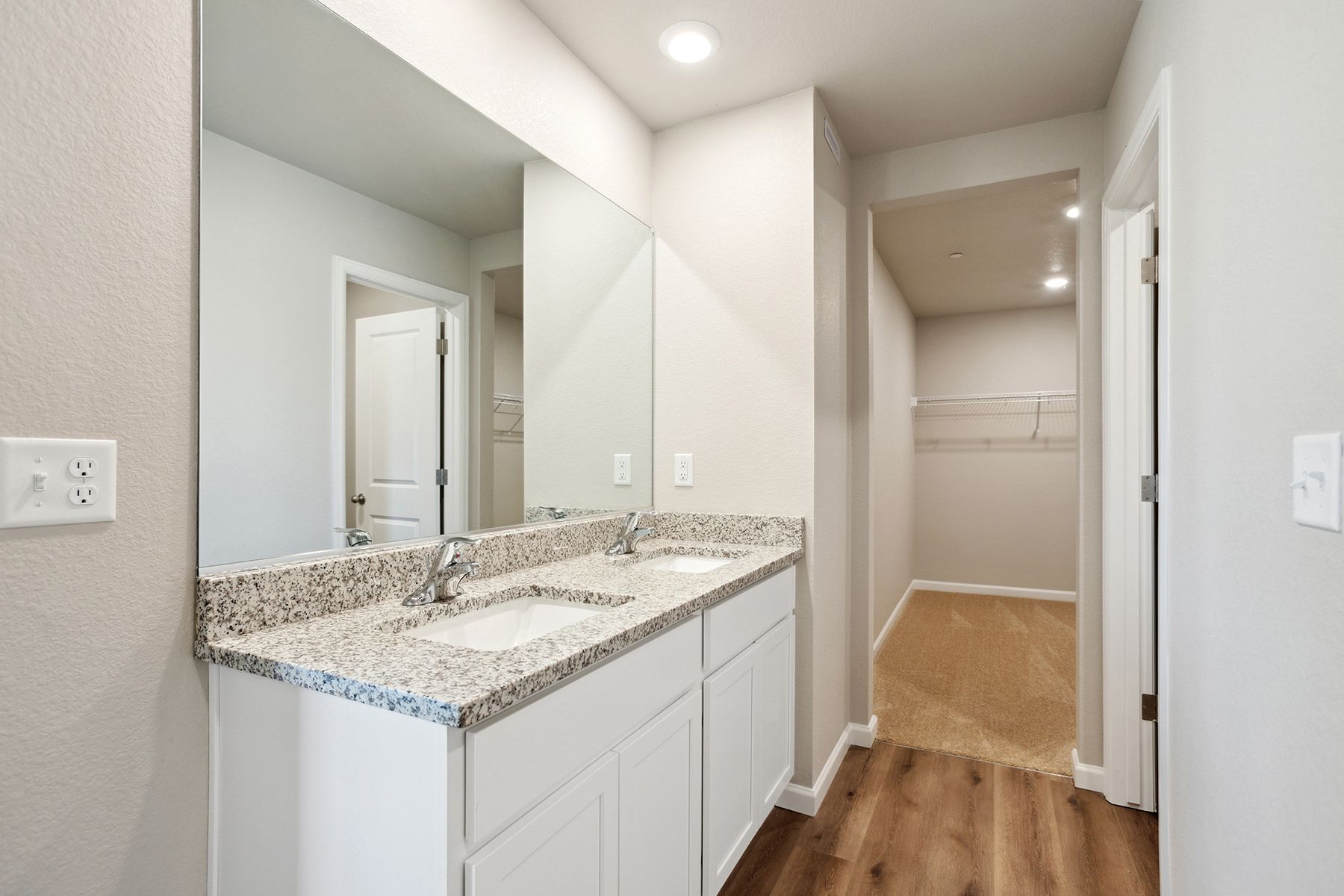 The master bathroom has a large vanity and tub/shower combo..