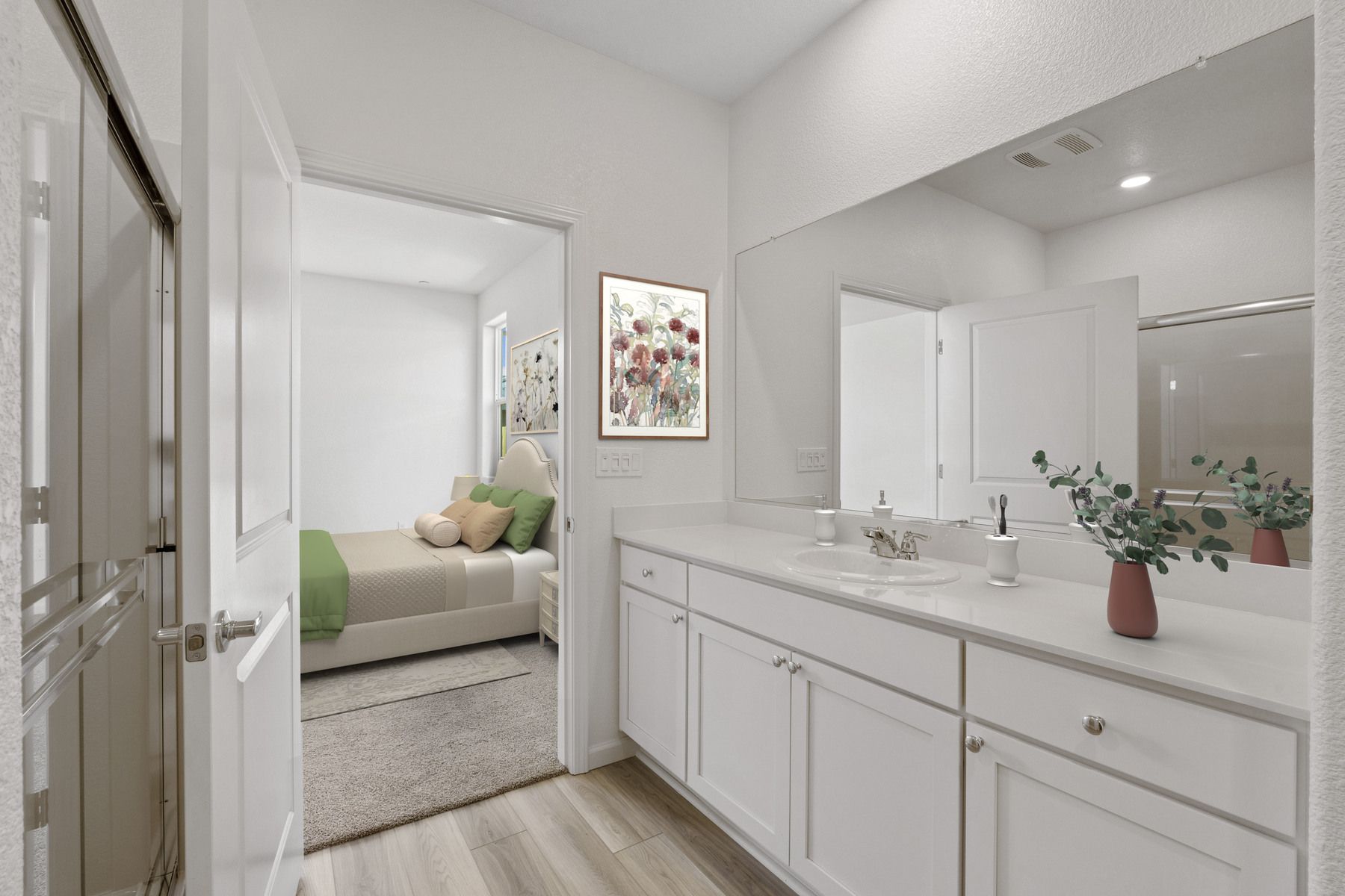 The master bathroom has a large vanity and a step in shower.