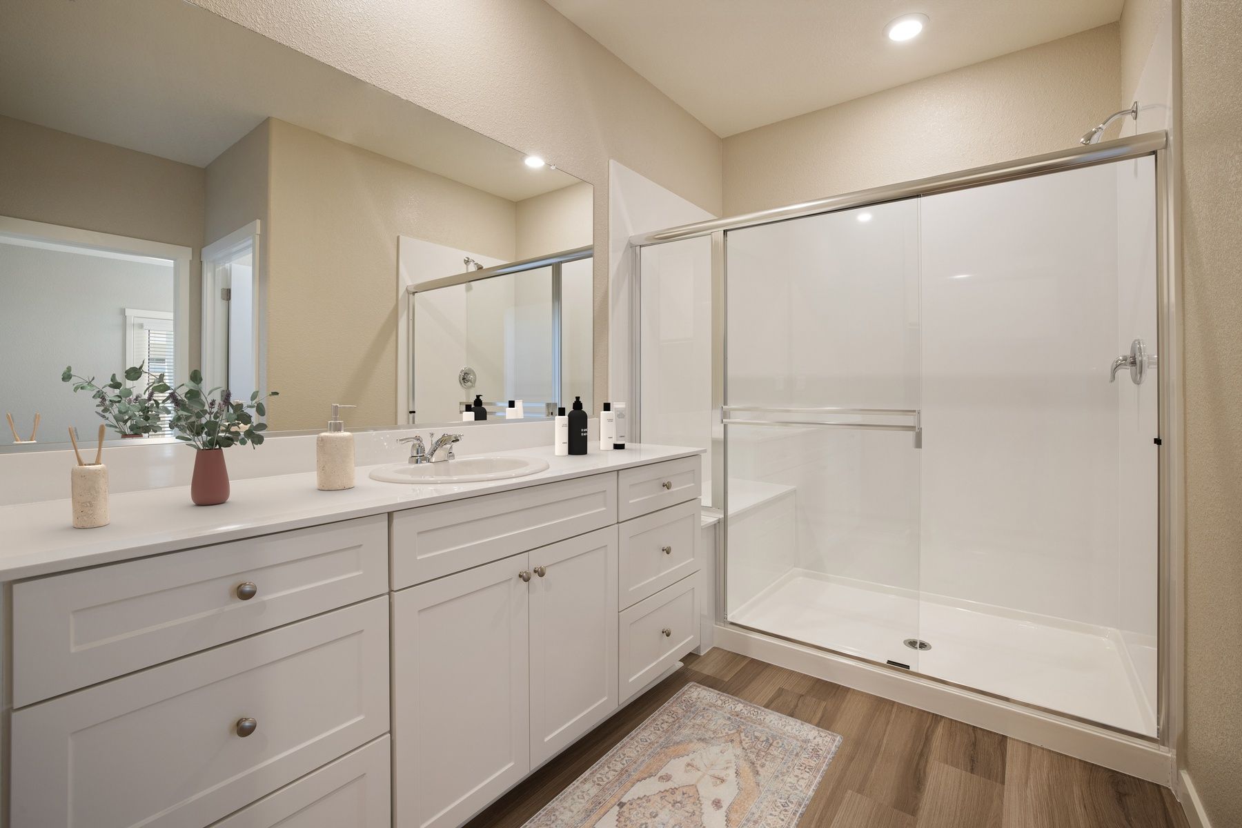 The master bathroom has a large vanity and a step in shower.