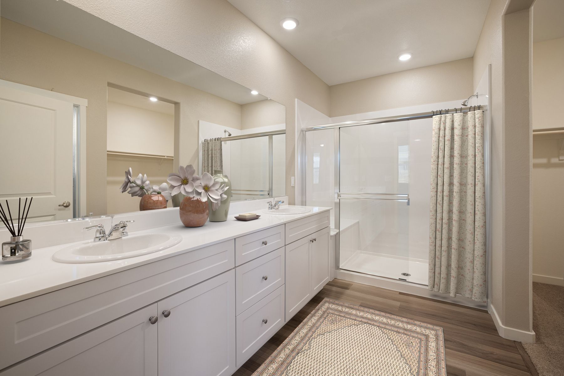 The master bathroom has a large vanity and a step in shower.