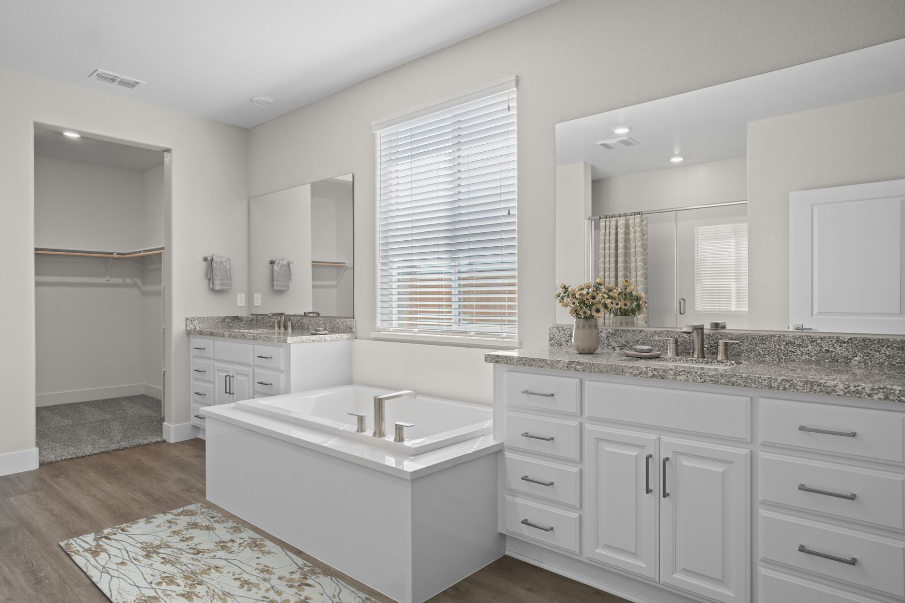 The master bathroom has a large vanity and a step in shower.