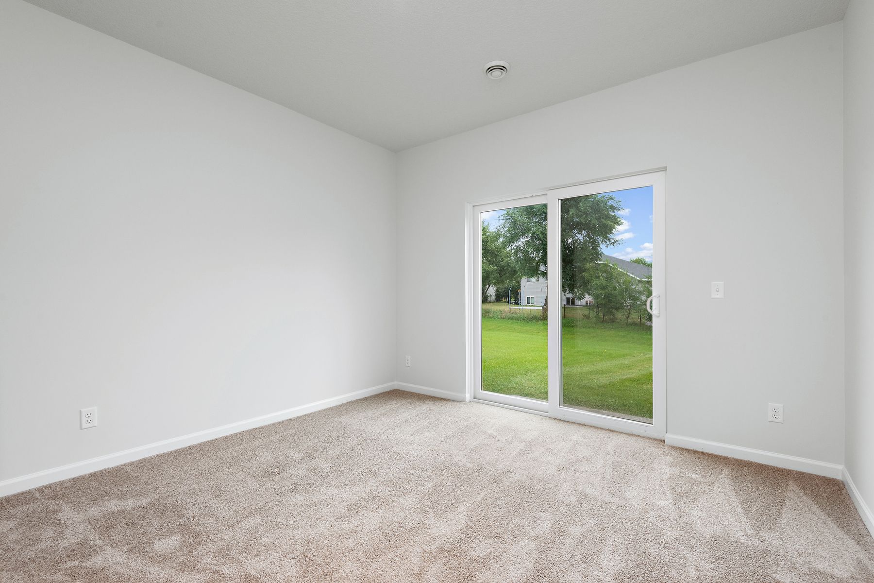 The master bedroom is spacious and has carpet.