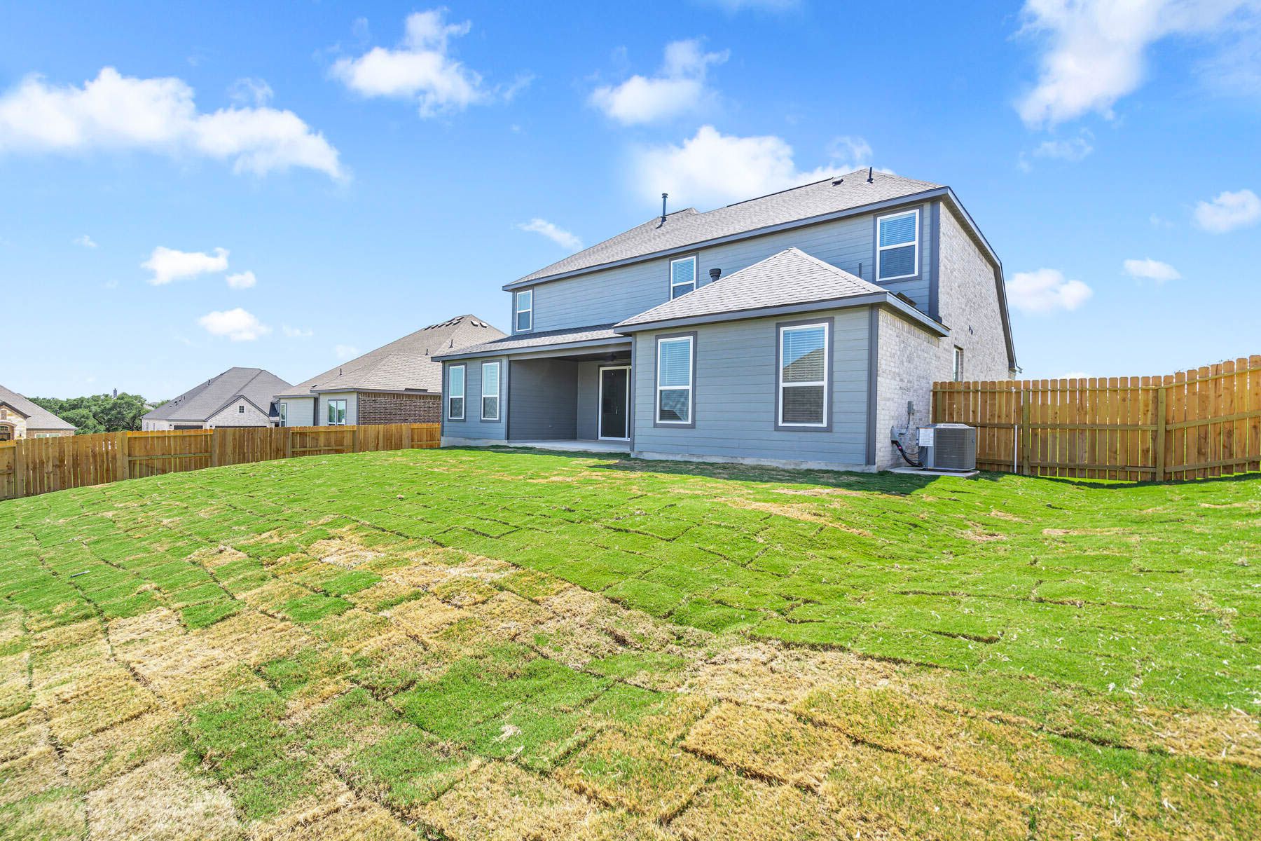 The back yard of the Santos is fully fenced-in.