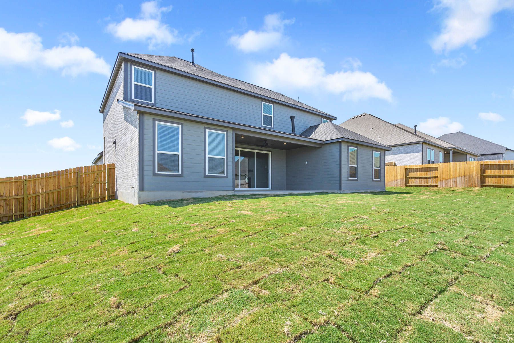The back yard is spacious with plenty of space for children and pets to run and play.