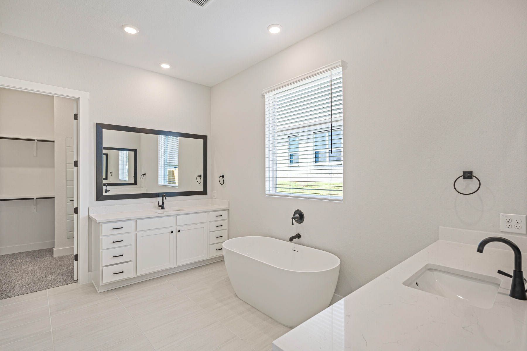 The vanities each have sprawling quartz countertops.