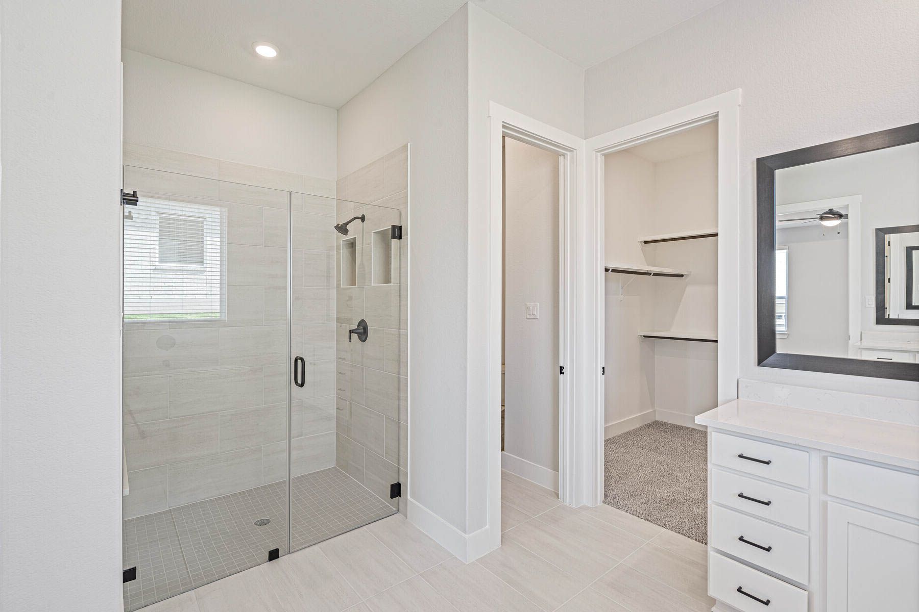 The master bathroom has a large walk-in, glass shower.