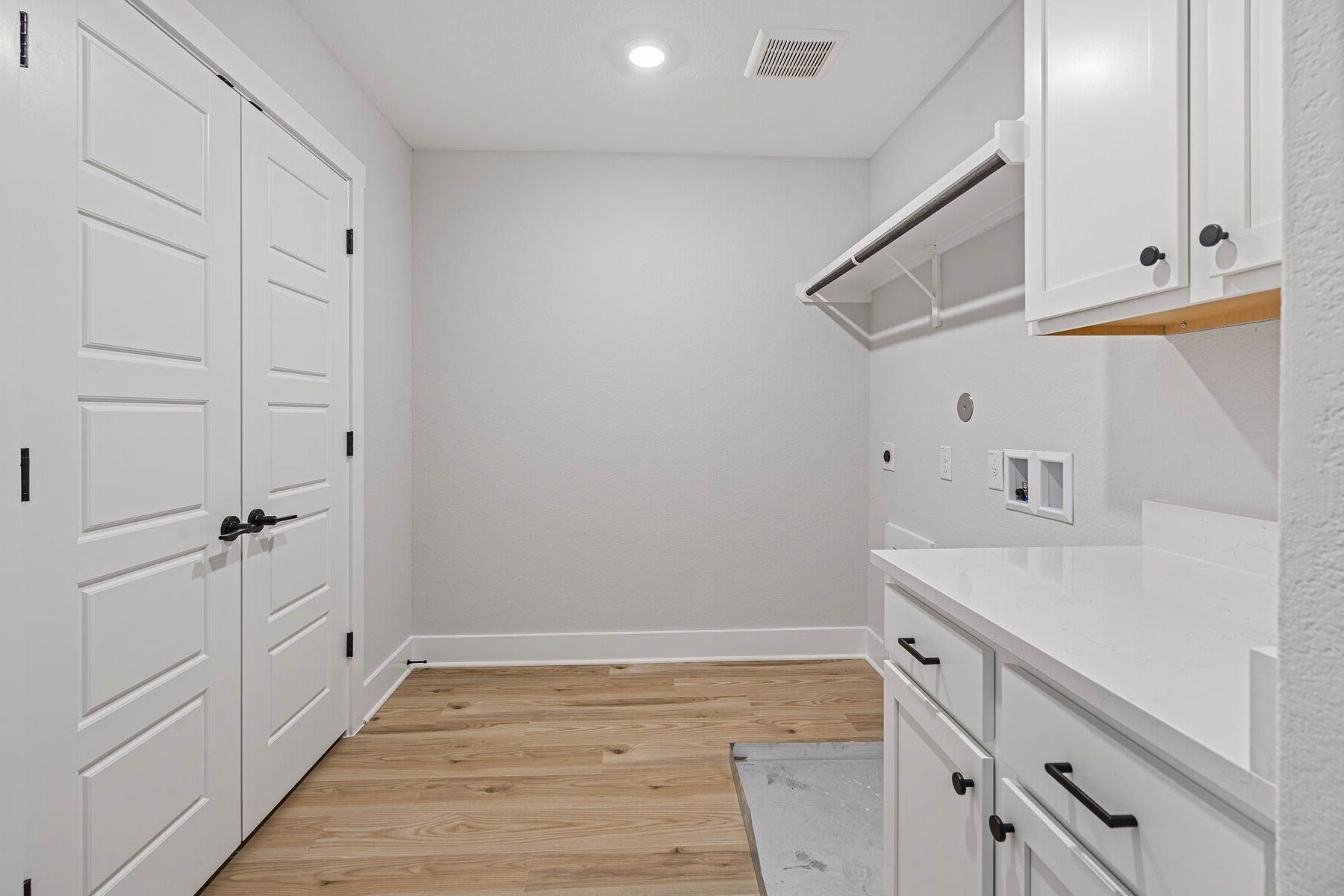The laundry room is upstairs and has hanging space and cabinet space.