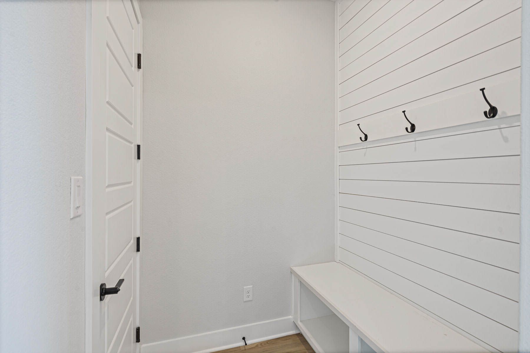 The mudroom has a bench and hooks.