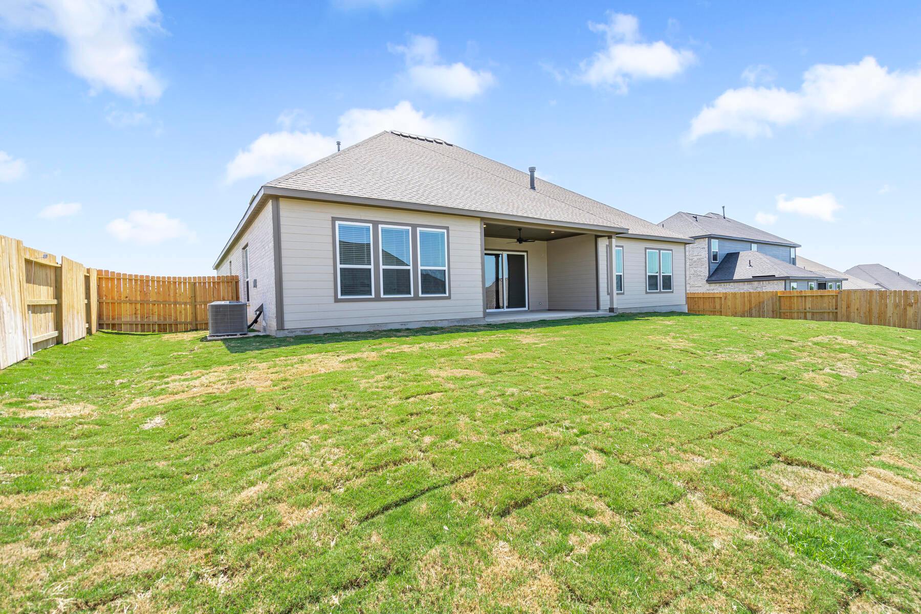 The back yard is fully fenced-in.