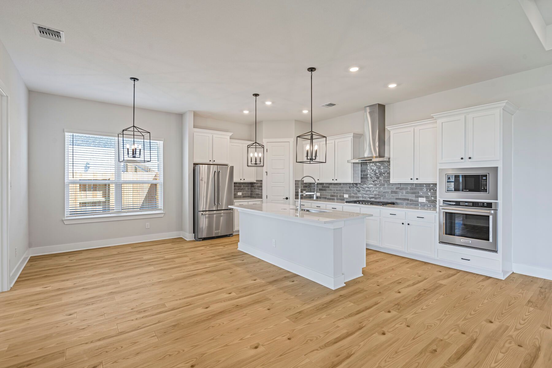 The kitchen and dining room sit adjacent to one another.