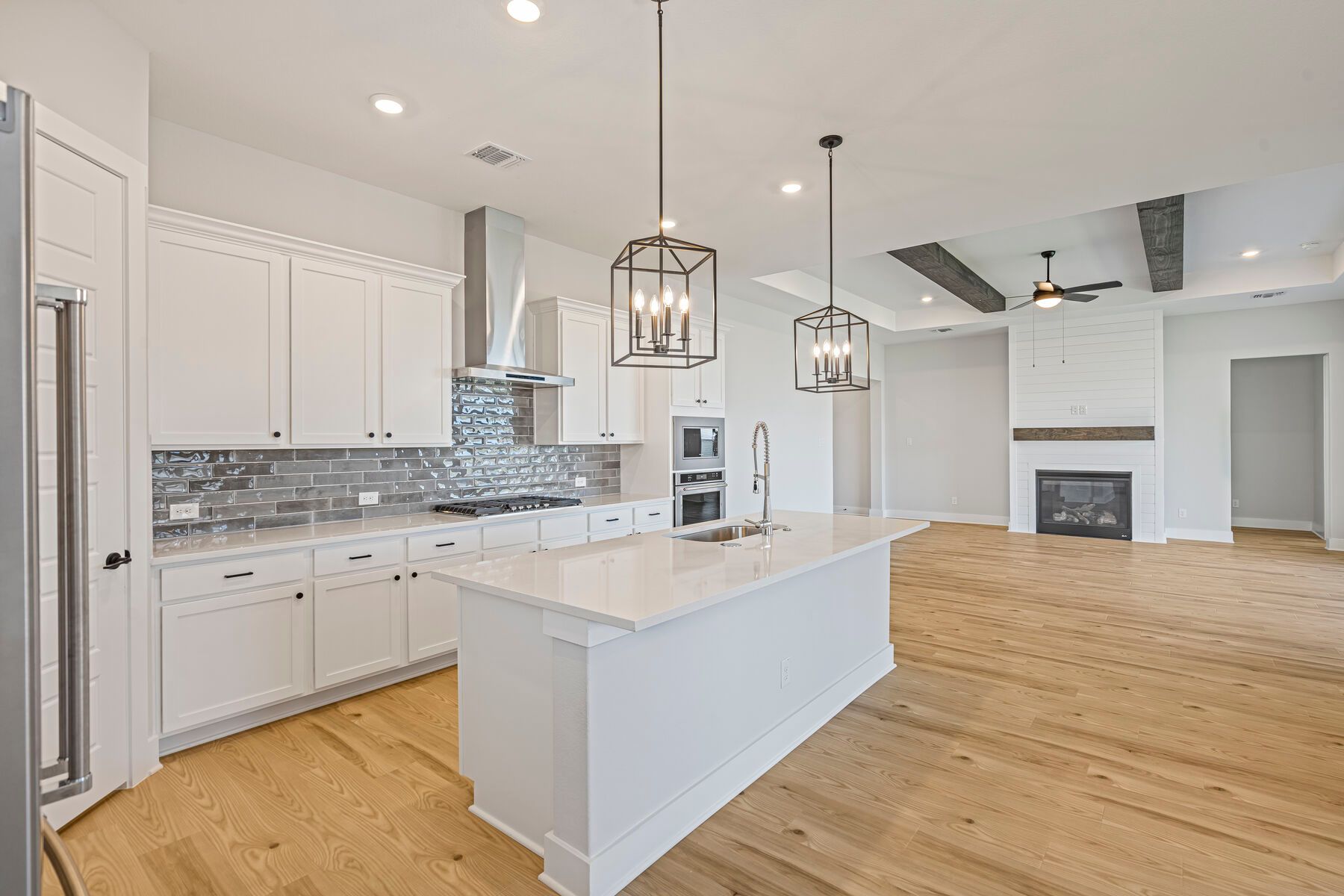 The kitchen has sprawling quartz countertops.