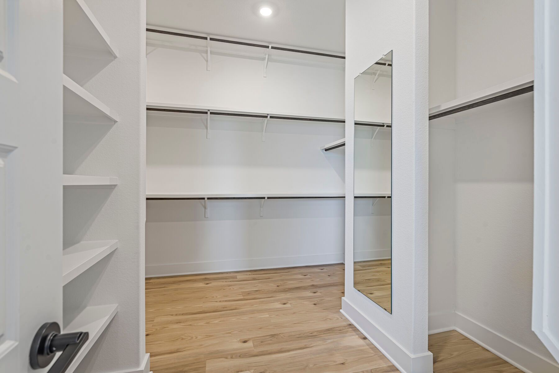 The walk-in closet in the master suite has plenty of haning and shelf space.