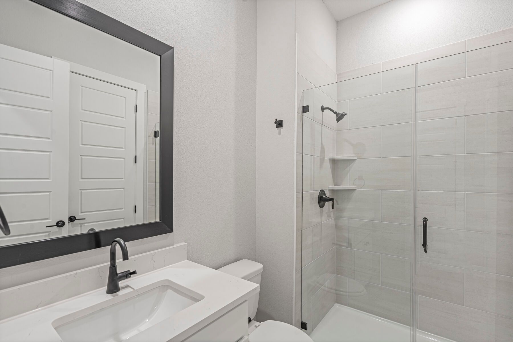 The third full bathroom has a nice vanity space and glass, walk-in shower.