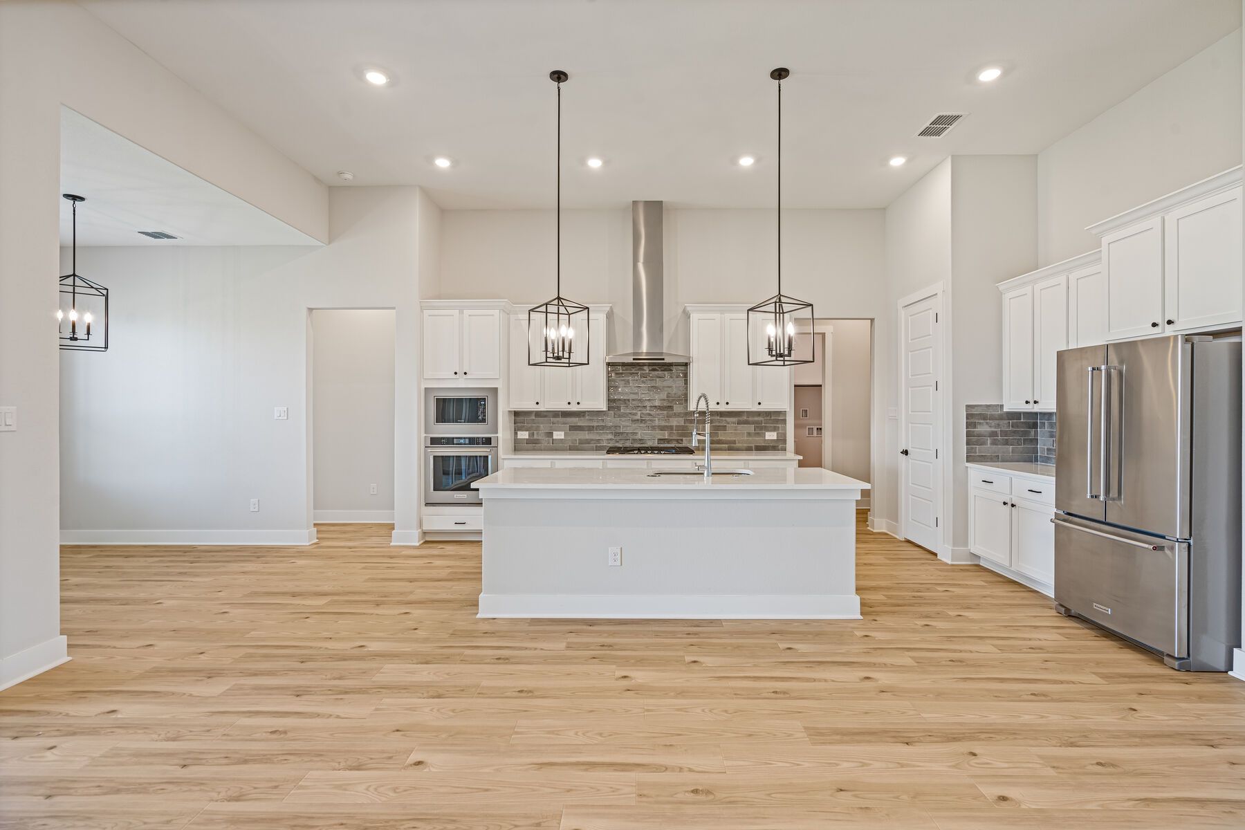 The kitchen has beautiful white cabinetry.