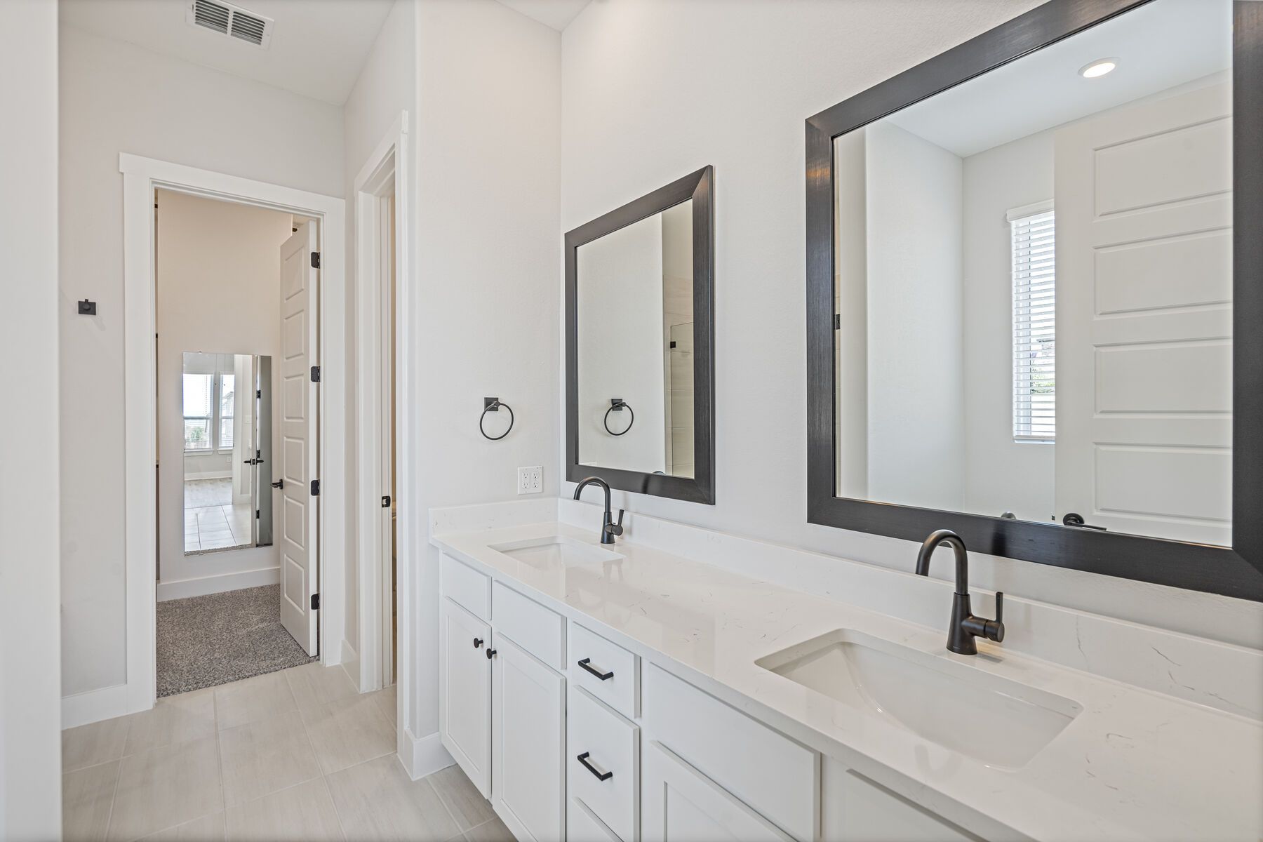 The master bathroom has a sprawling dual-sink vanity.