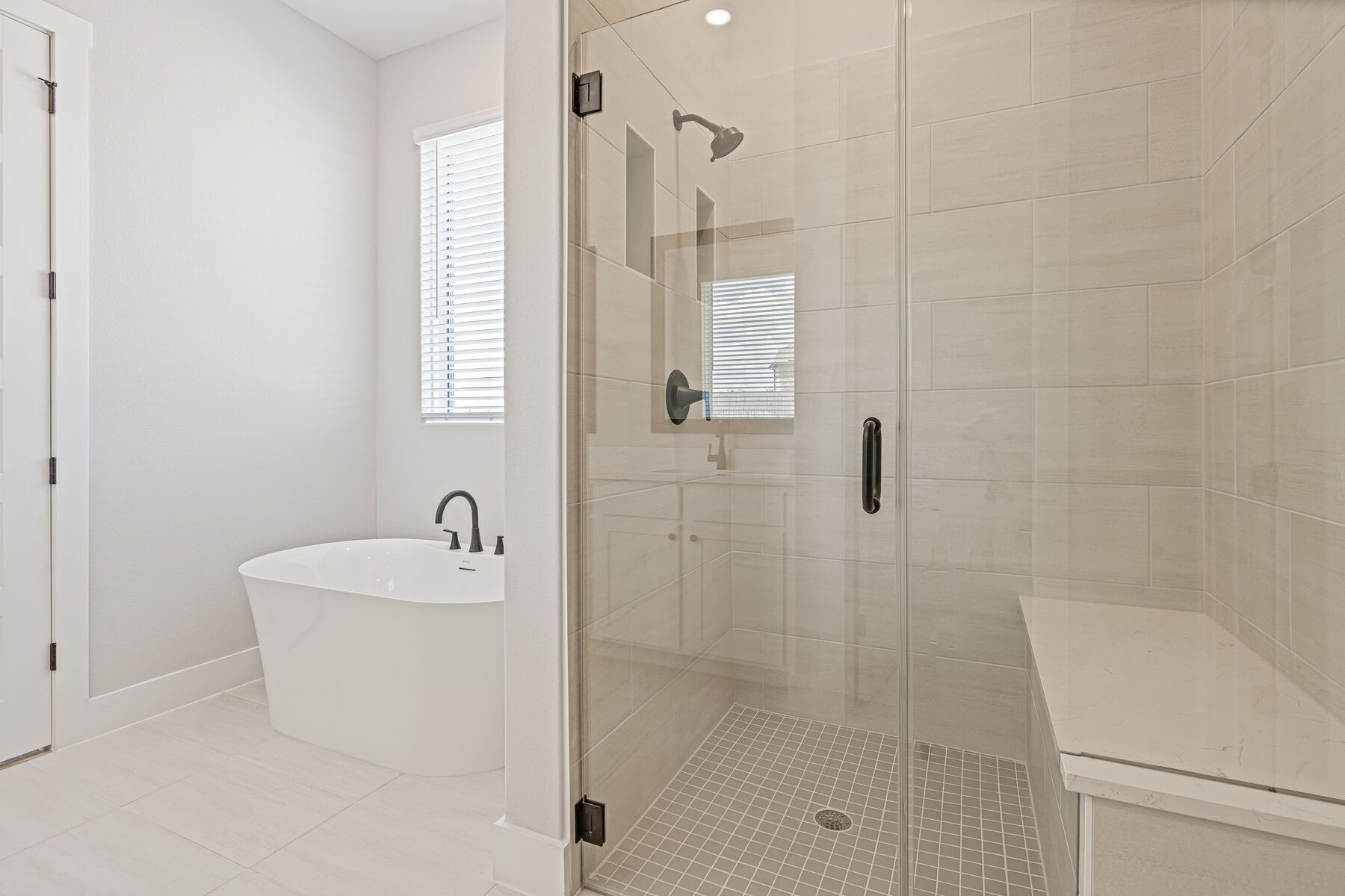The master bathroom has a glass, walk-in shower and a stand alone tub.