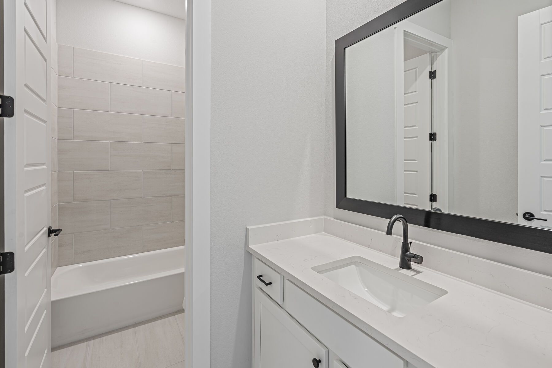 The secondary bathroom has a sprawling vanity space.