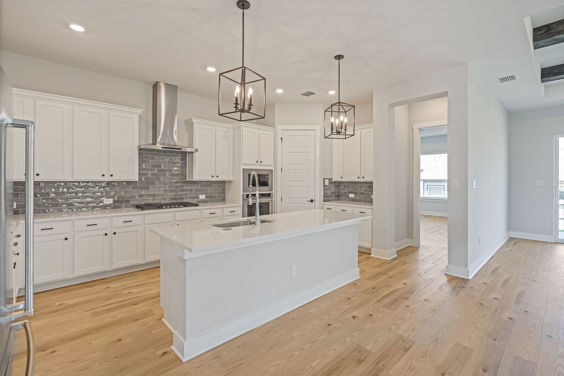 The kitchen has sprawling quartz countertops.