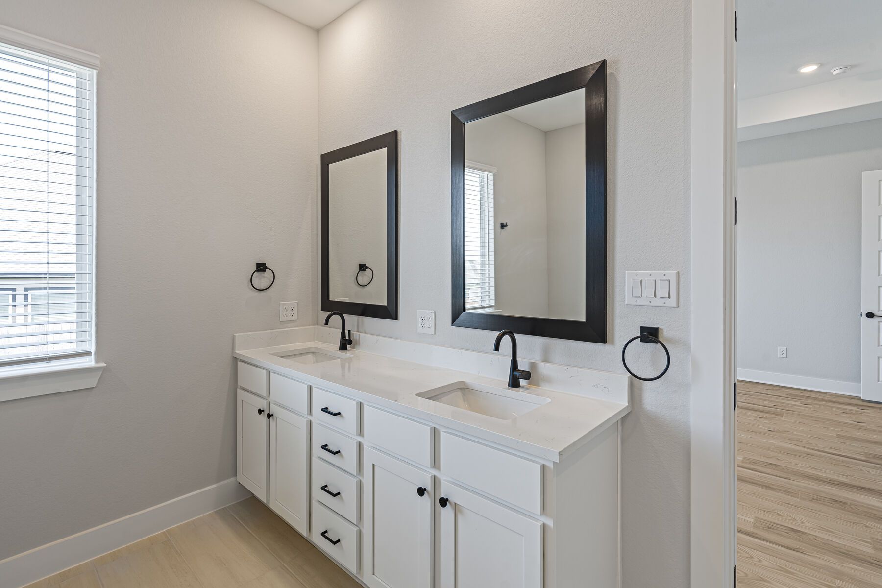 The master bathroom has a sprawling dual sink vanity.