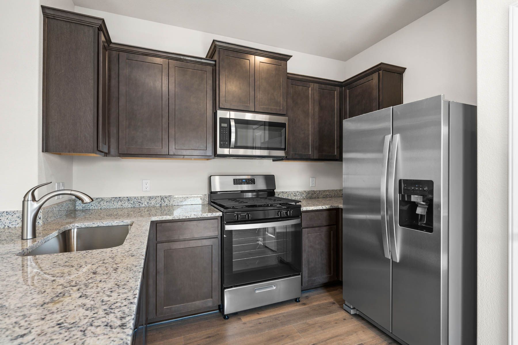 The kitchen has beautiful brown cabinets.
