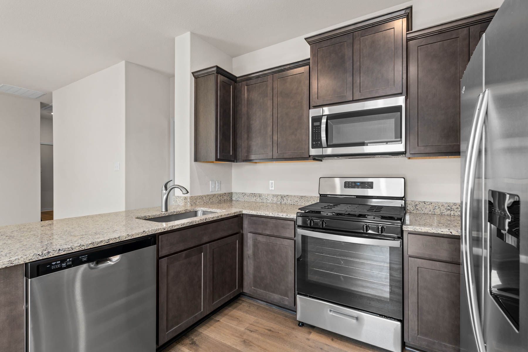 The kitchen has stainless steel appliances.