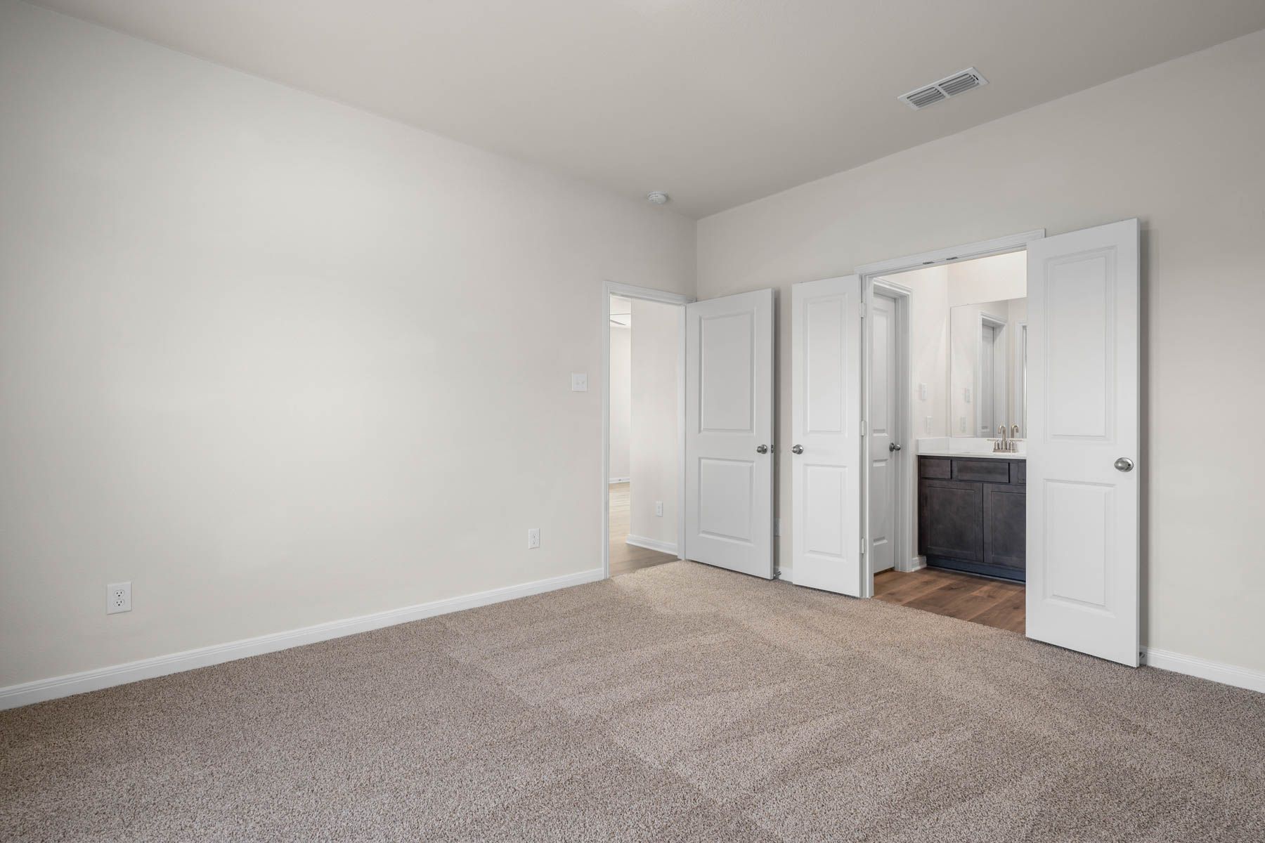 The master suite has a large bedroom, ensuite bathroom and a walk-in closet.