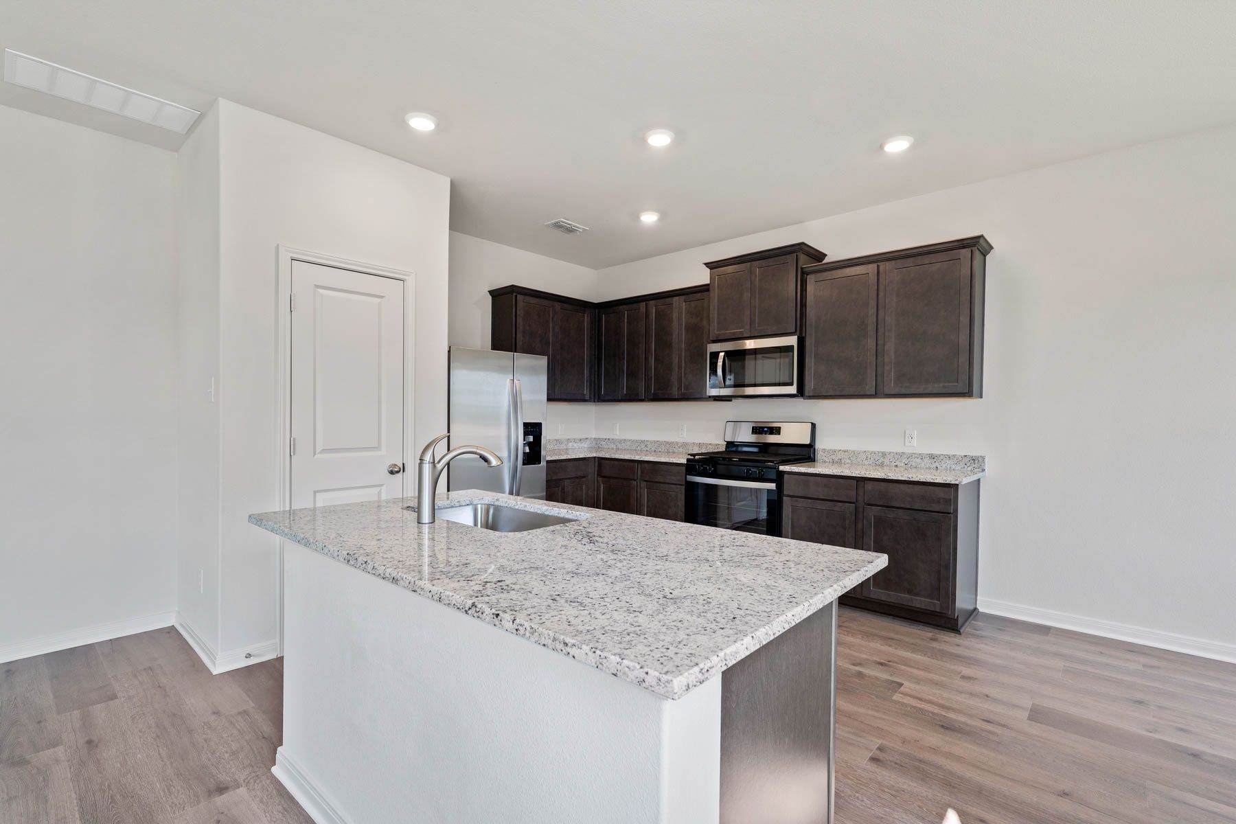 The kitchen has beautiful wood cabinetry.