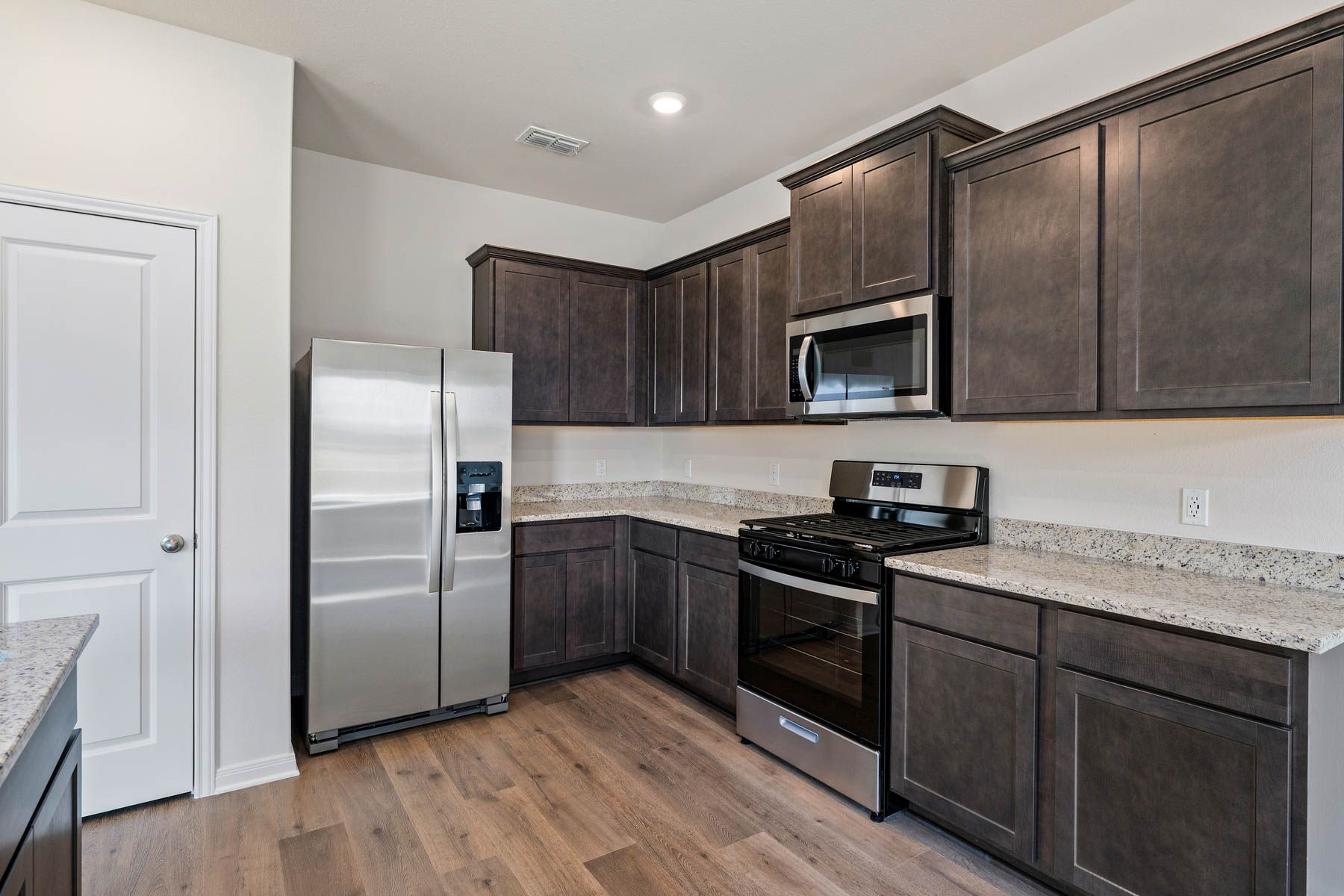 The kitchen has sprawling granite countertops.