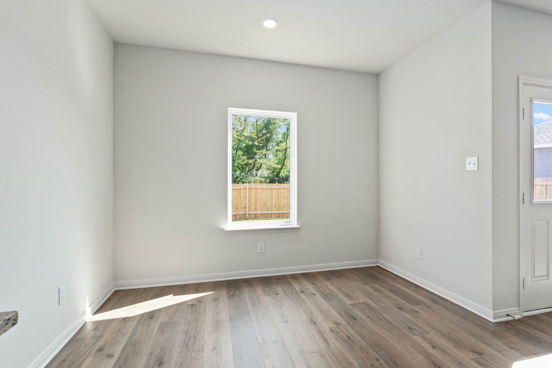 The dining room has a large window that lets in great, natural light.