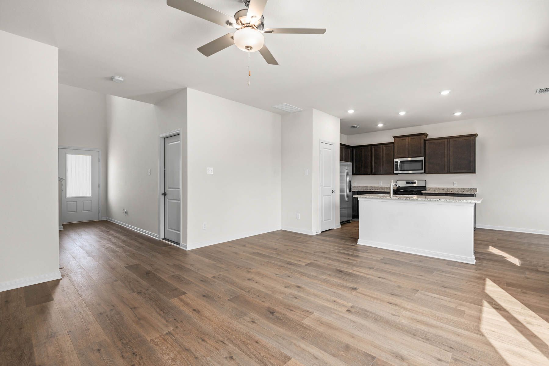 The living room is spacious and has plenty of room for furniture. 