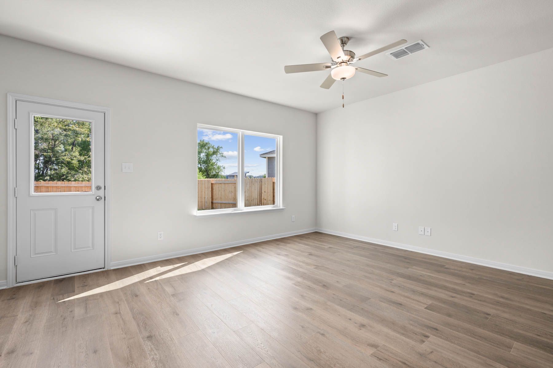 The living room has a large window that lets in great, natural light.