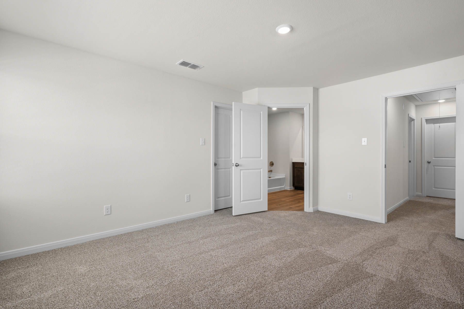 The master suite has a large bedroom, ensuite bathroom and walk-in closet.