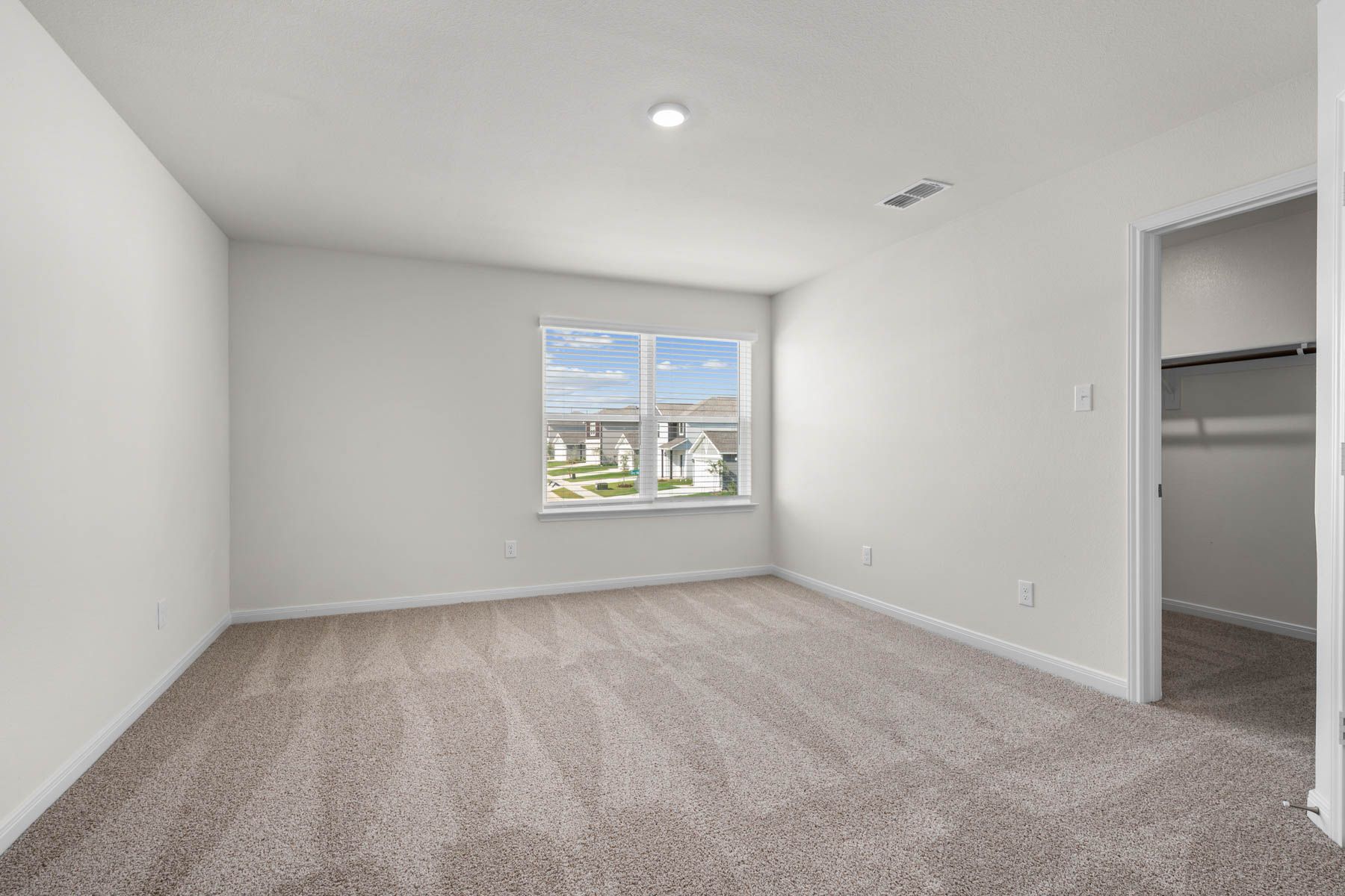 The master bedroom has a large window that lets in great, natural light.