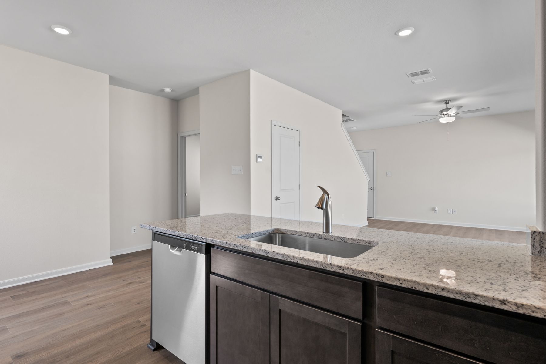 The kitchen looks out into the family room.