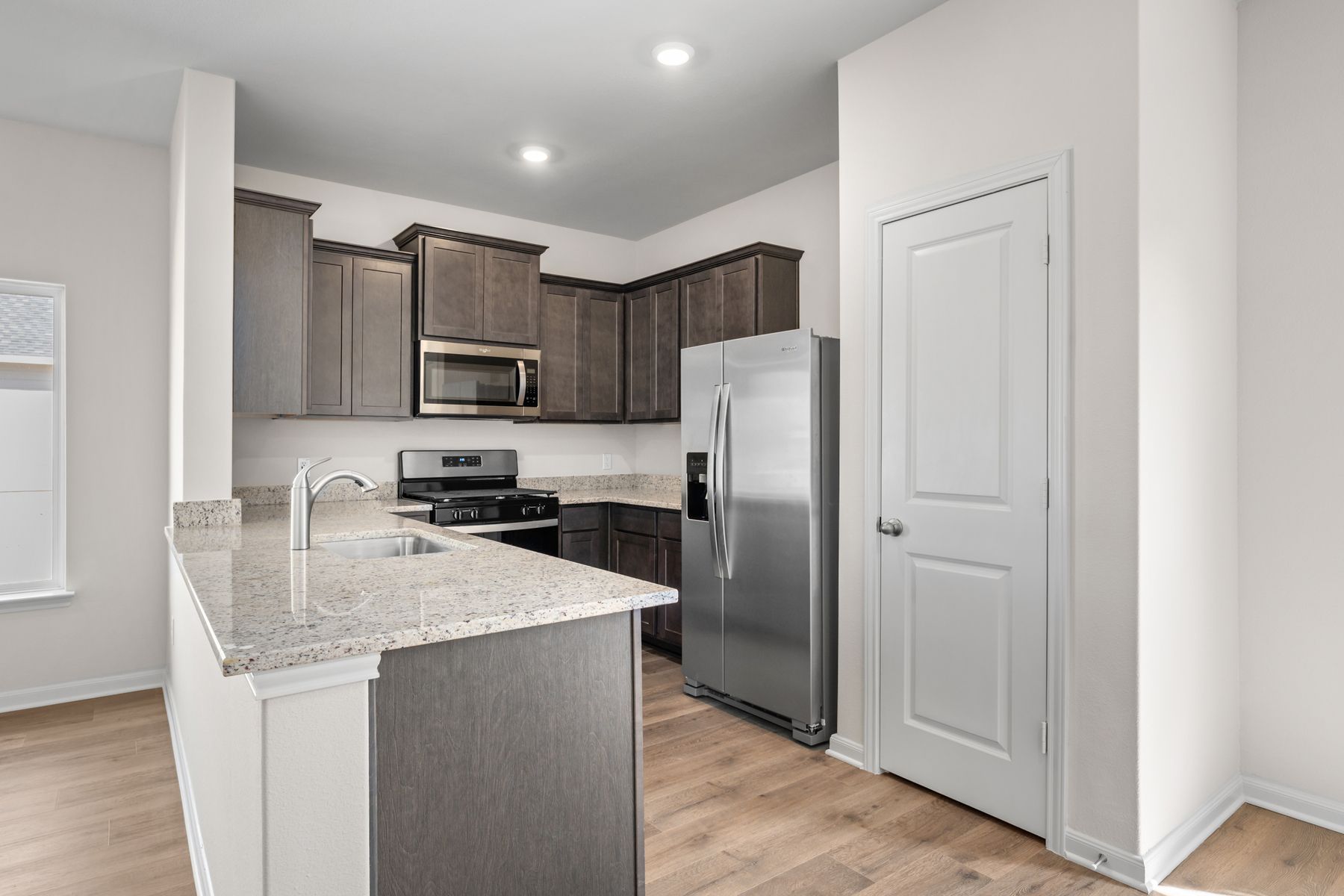 The kitchen of the Primrose has sprawling granite countertops.