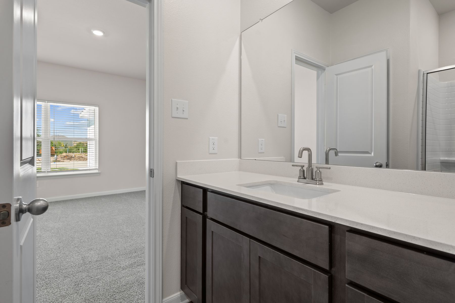 The master bathroom has a sprawling vanity.