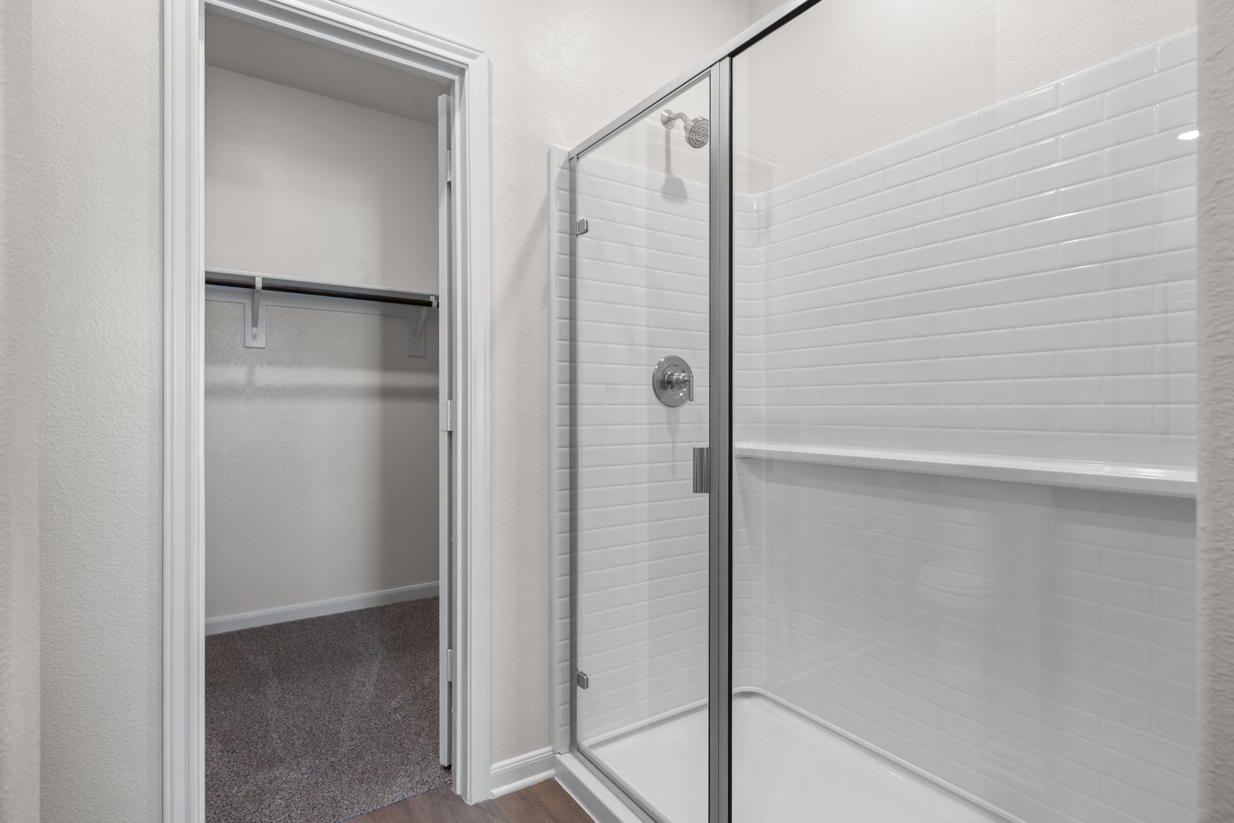 The master bathroom has a glass, walk-in shower.