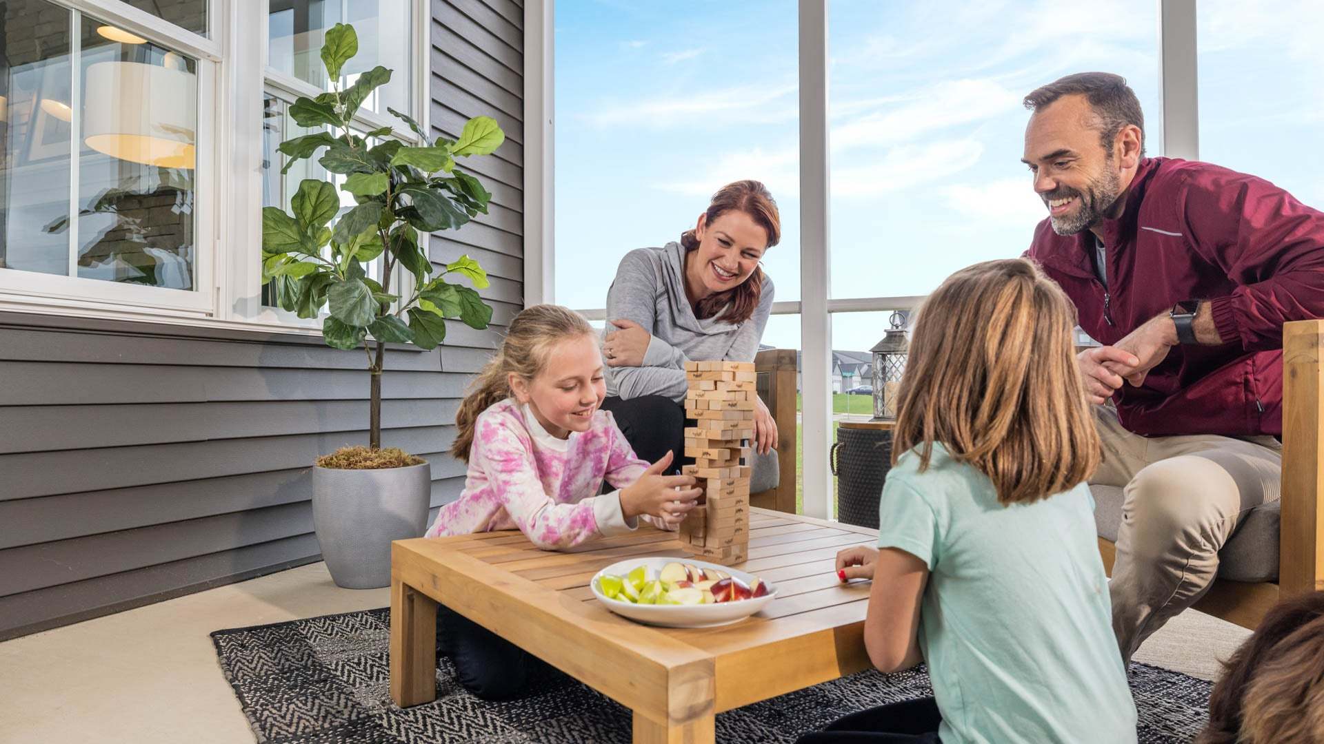 Family Playing Games on Screened In Porch