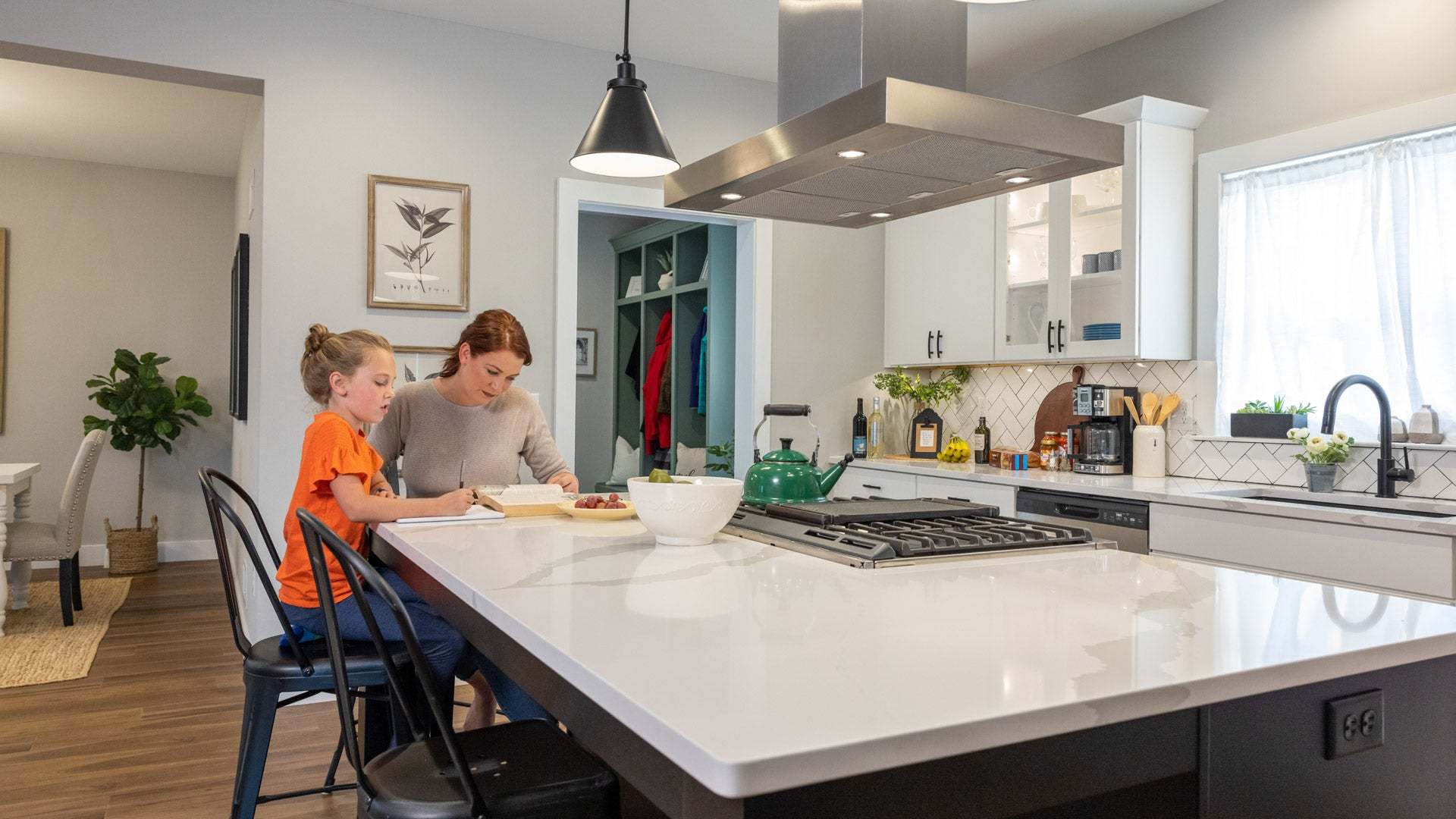 Mother Helping Child Study at New Kitchen Island