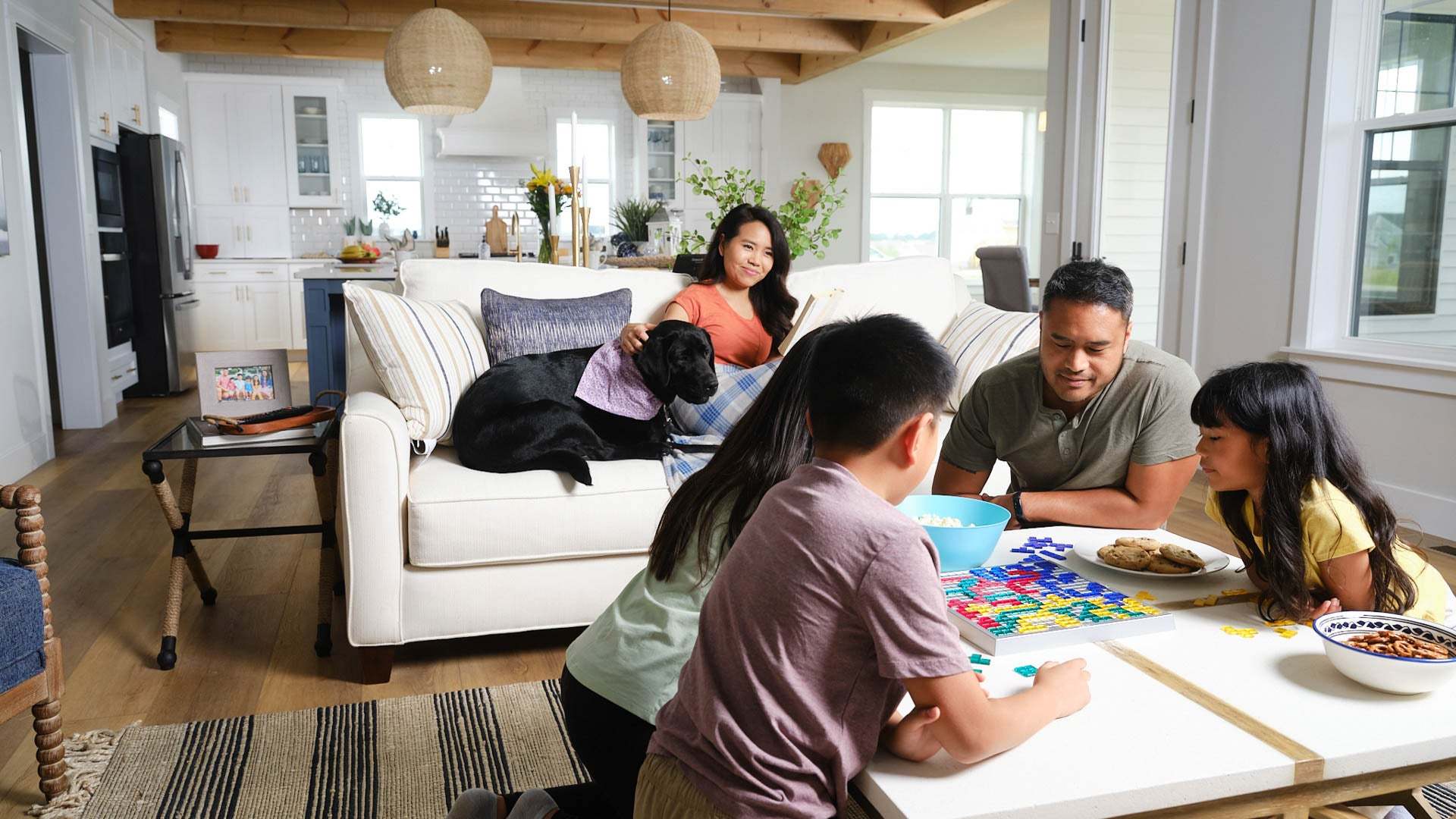 Family Playing Games in Great Room of New Home by Landmark Homes