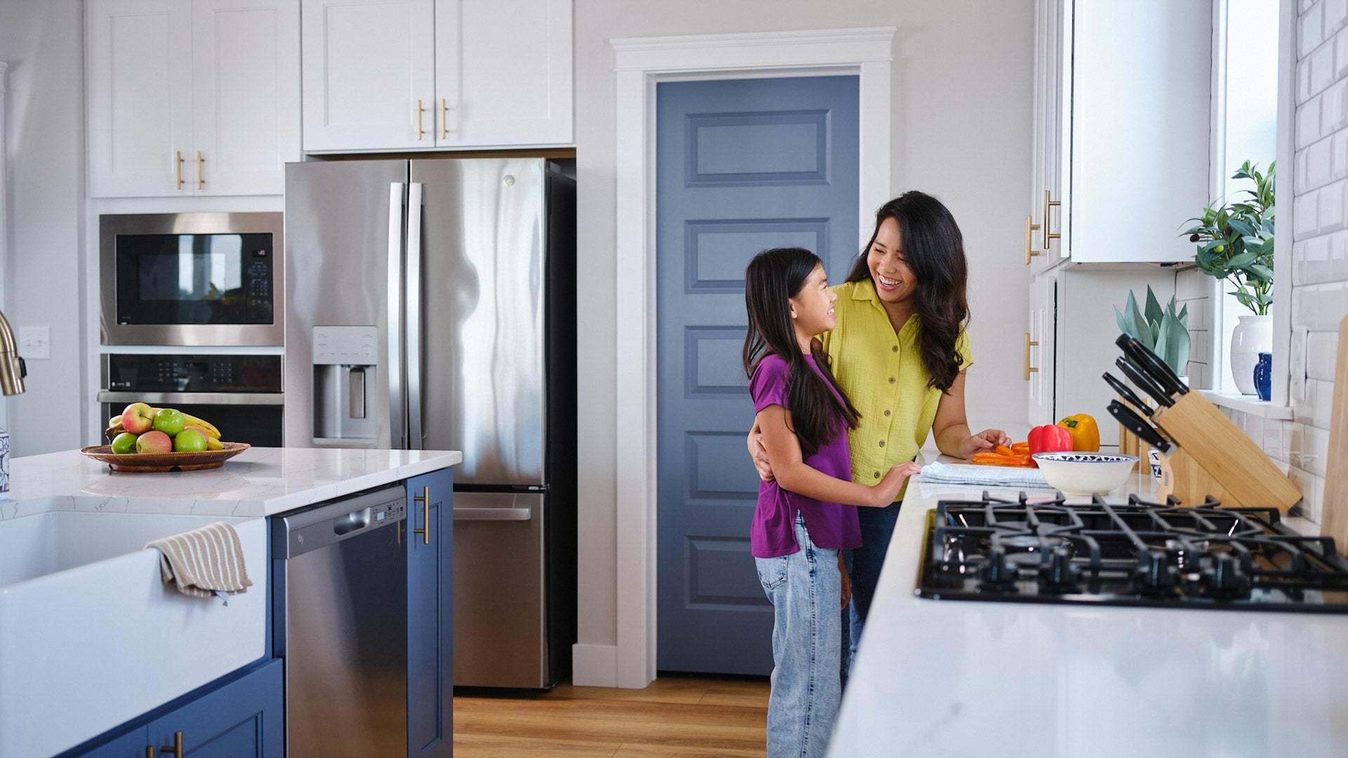 Mom and Daughter Preparing Food in New Home by Landmark Homes