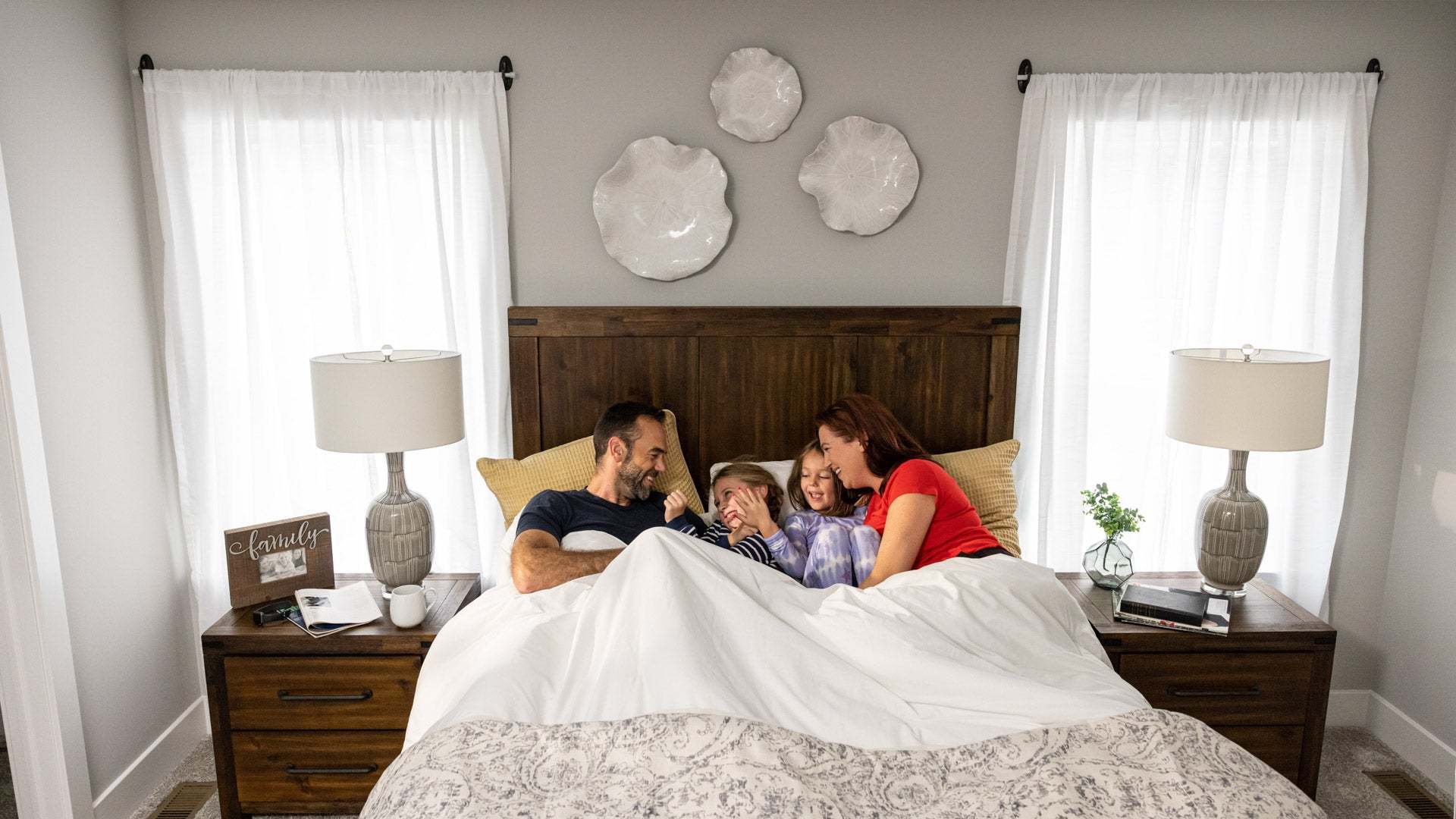 Family Relaxing in Primary Suite in New Landmark Home