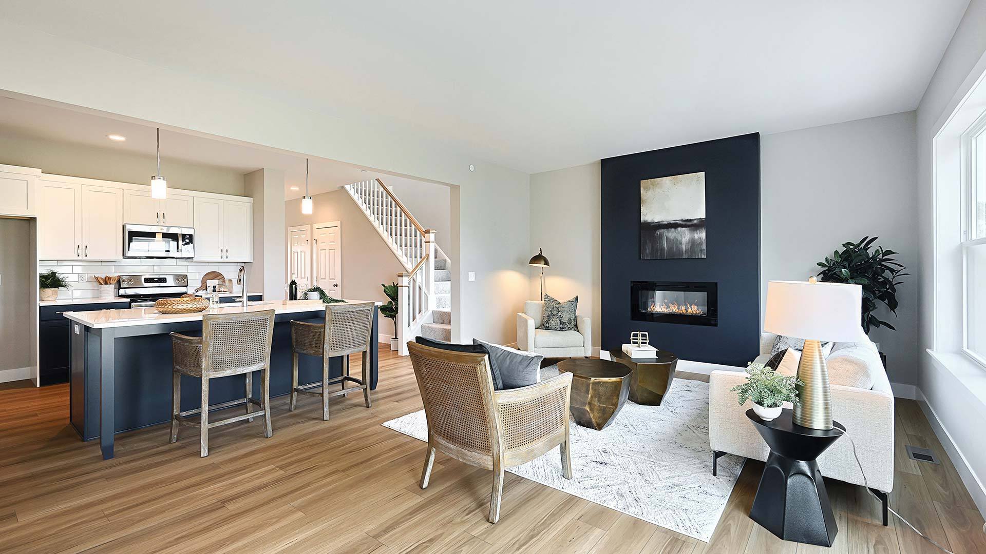 Living Room and Kitchen with Modern Electric Fireplace in New Townhome by Landmark Homes